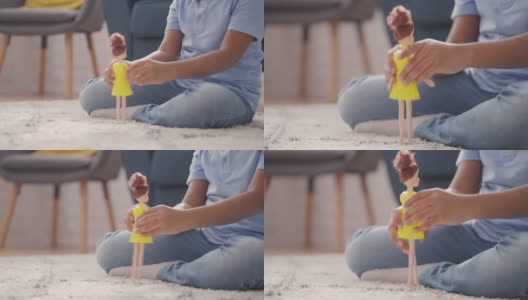 小男孩在地板上玩洋娃娃，打破性别刻板印象的玩具高清在线视频素材下载
