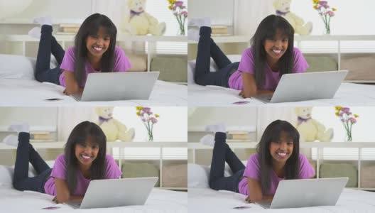 非洲裔美国女孩微笑着拿着笔记本电脑高清在线视频素材下载