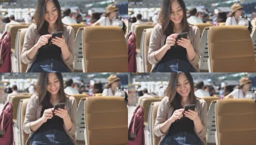 一名女子在机场候机室使用手机高清在线视频素材下载