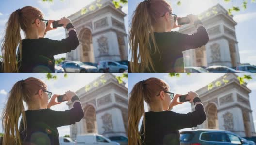 游客走在巴黎街头，拍摄凯旋门的照片高清在线视频素材下载