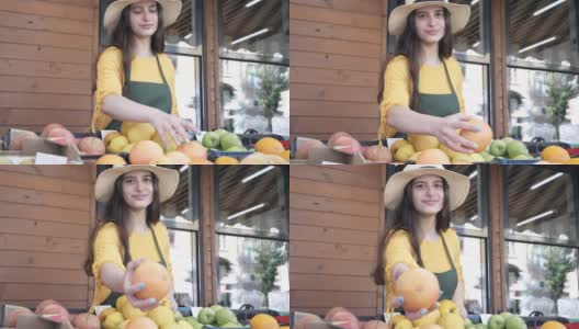开朗的女蔬菜水果商在农贸市场提供本地产品高清在线视频素材下载