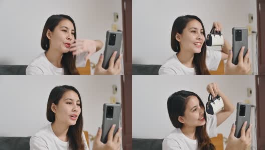 年轻的亚洲女性用智能手机与朋友视频通话，展示腕带作为礼物高清在线视频素材下载