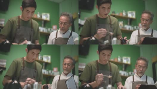 亚洲华人男咖啡师咖啡店老板正在和他的员工进行冷煮咖啡点滴培训高清在线视频素材下载