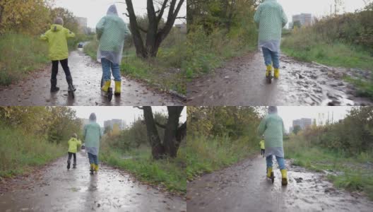 两个穿着雨衣、黄夹克和胶靴的男孩骑着马穿过水坑高清在线视频素材下载