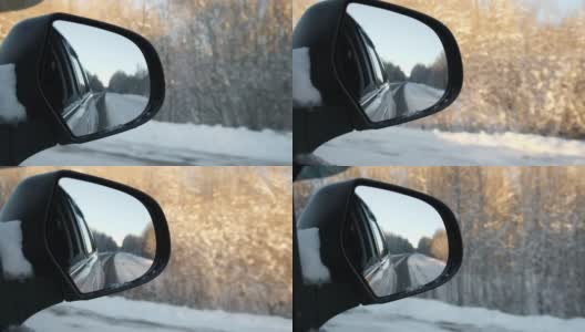 冬季森林道路的侧视镜反射。风景与空旷的高速公路穿过雪原森林。汽车在路上超速行驶。汽车在运动。旅游，旅行，旅行概念。冰雪覆盖的树木。高清在线视频素材下载