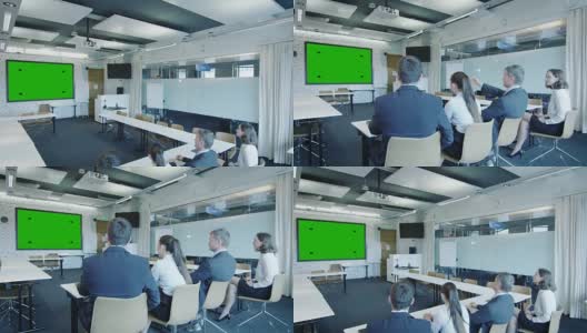 一群上班族在会议室里看绿屏。伟大的模型使用。高清在线视频素材下载