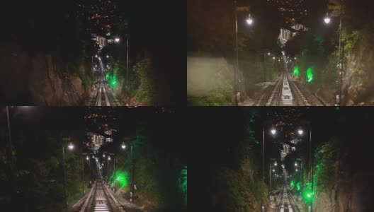 现代无人驾驶的地铁列车向前疾驰，沿着马来西亚的夜幕，地上的铁路，夜晚明亮的路灯。1920 x1080高清在线视频素材下载