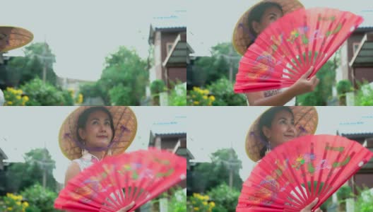 4K年轻亚洲女性穿着中国传统服饰旗袍和越南锥形帽子。高清在线视频素材下载