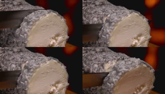 这是一个圣马ure de Touraine山羊奶酪的特写，稻草在中间高清在线视频素材下载