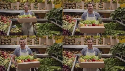 一名友善的男子正准备在一个装满新鲜水果和蔬菜的纸箱里为顾客送货，微笑着看着相机高清在线视频素材下载