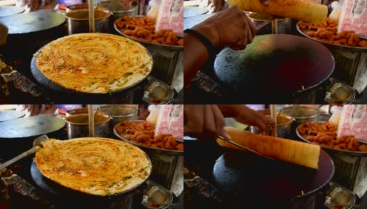 印度孟买，熟练的街头小吃小贩正在做印度薄饼高清在线视频素材下载