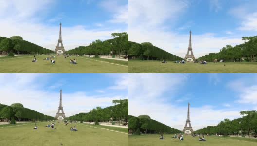 从战神广场看巴黎的埃菲尔铁塔。游客和当地人在草坪上休息高清在线视频素材下载