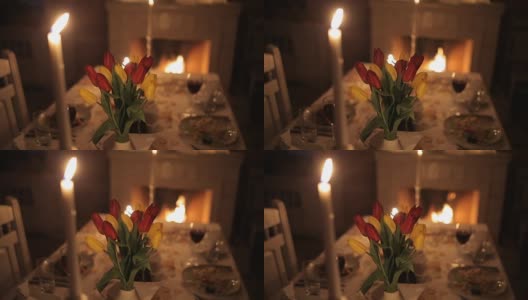 一对恩爱的夫妇在壁炉旁的烛光下进餐高清在线视频素材下载