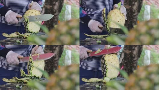 女商人正在用刀削菠萝皮。高清在线视频素材下载