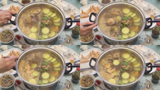 概念火锅家庭烹饪。用撇子把蘑菇从沸腾的汤中捞出来高清在线视频素材下载