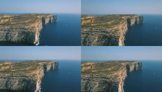 风景鸟瞰图戏剧性的高悬崖与美丽的海景。游艇在海上航行。无人机俯视图拍摄的危险石崖。Gozo岛、马耳他高清在线视频素材下载
