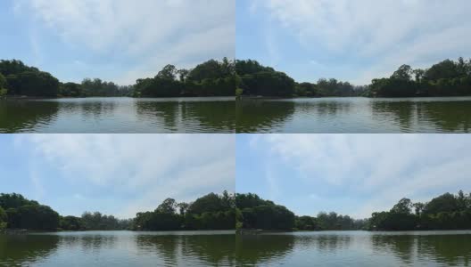 湖面映着天空，远处有一条树线，可循环高清在线视频素材下载