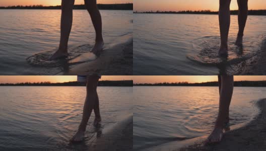 男性的腿和脚沿着湖或池塘在黄昏的沙滩上行走。人们只能在岸上行动。背景是平静的水。120帧/秒的慢动作。夕阳下，一个人在海湾或小溪沐浴后散步高清在线视频素材下载