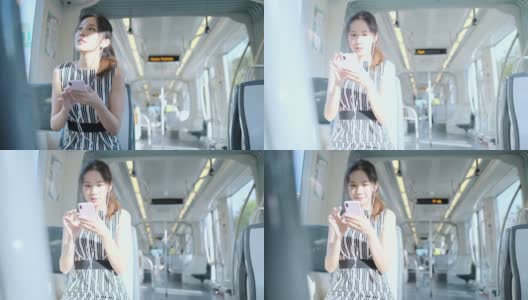 年轻女子在乘坐地铁上下班时使用手机高清在线视频素材下载