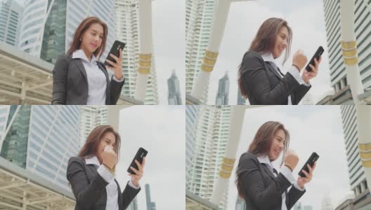 亚洲失业妇女感到高兴后，她看智能手机知道结果，她已经通过了面试的业务办公室在大公司。高清在线视频素材下载