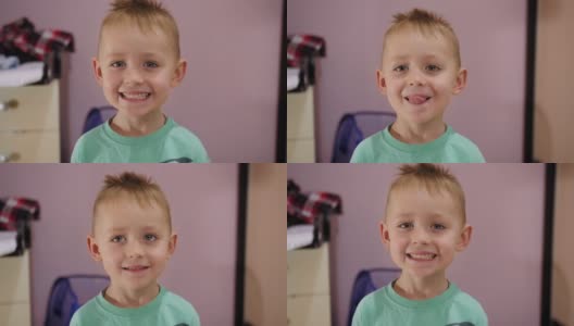 房间里一个金发碧眼的可爱男孩的肖像站在镜头前。高清在线视频素材下载