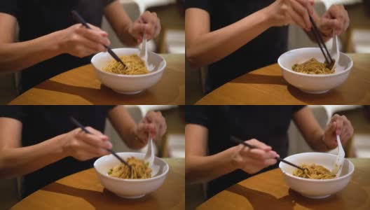 妇女一边搅拌一边用筷子吃炸酱面高清在线视频素材下载