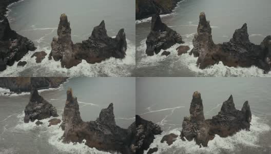 鸟瞰冰岛的山脉巨怪脚趾，海鸥在上面筑巢。直升机在黑海滩的悬崖上盘旋高清在线视频素材下载