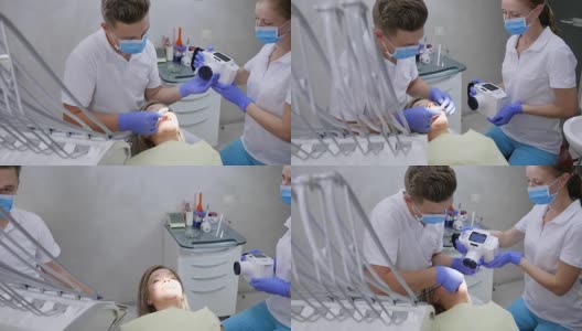 医生用特殊的牙科相机在办公室里用现代化的设备拍摄女病人的口腔高清在线视频素材下载