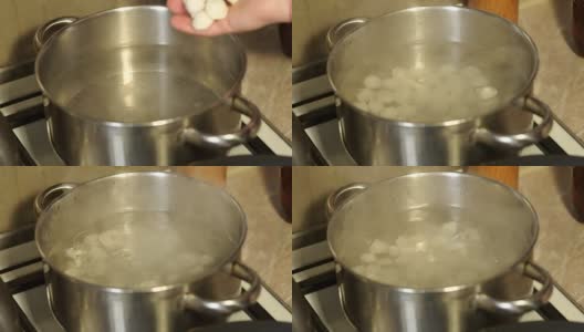 一个女孩在平底锅里煮饺子的特写。高清在线视频素材下载