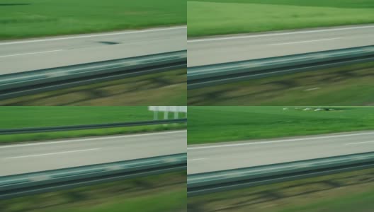一辆快速行驶的公共汽车窗外的景色。宽阔的高速公路高清在线视频素材下载