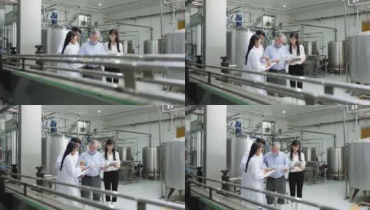 一个老头儿和两个年轻女工在工厂里细心检查机器高清在线视频素材下载