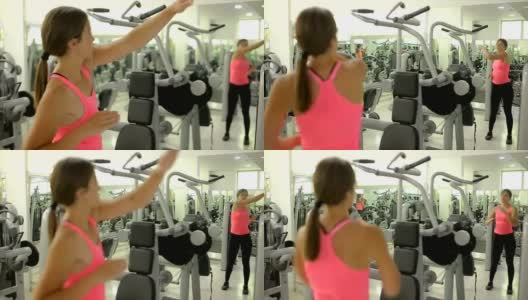 强壮的年轻女子在健身房伸展她的手臂高清在线视频素材下载