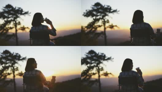 女人在户外放松与咖啡杯在山上的日落时间高清在线视频素材下载