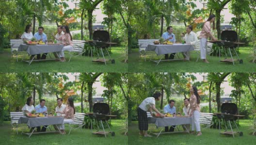 一家人在花园里享受烧烤。高清在线视频素材下载