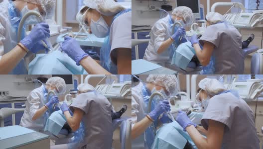 两名年轻的女牙医正在一家医院的牙科诊所里做面部保护手术。戴口罩和手套。保健和医学的概念。高清在线视频素材下载