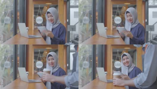 快乐多元的亚洲穆斯林年轻女子与朋友在咖啡馆会议上谈笑风生，多元文化开朗的人们围坐在café桌边喝咖啡高清在线视频素材下载