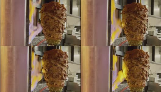 在烤肉架上，一个喷着火焰的唾沫射向Al Pastor，把它烤到完美高清在线视频素材下载