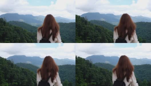 一个女旅行者看着美丽的山景的慢镜头高清在线视频素材下载