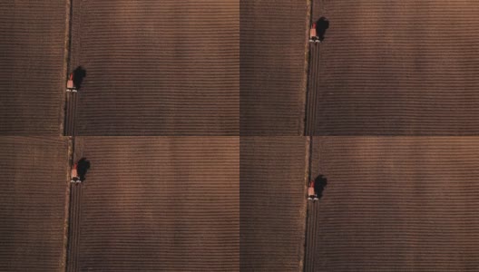 无人机视角的农民驾驶拖拉机作物种植机在田间高清在线视频素材下载