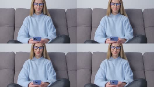 快乐的年轻女子在现代手机上打字。一名戴着眼镜的白皙金发女性，在4k拍摄的社交媒体应用程序中使用新智能手机进行在线交流高清在线视频素材下载