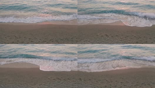 希腊爱奥尼亚岛莱夫卡达美丽的米洛斯海滩的低空鸟瞰图。夕阳金色的阳光和原始的海浪打破了蓝绿色的大海在岸边高清在线视频素材下载