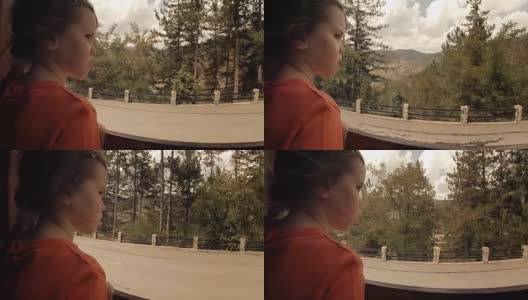 火车上的孩子——一个小女孩享受她的第一次火车旅行。山景窗外高清在线视频素材下载