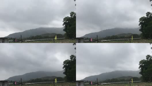 时间推移-湿气云移动越过山区农民的栅栏旗帜高清在线视频素材下载
