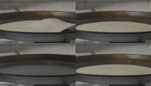 在煎锅里煎薄饼，在煎锅里煎薄饼的过程高清在线视频素材下载