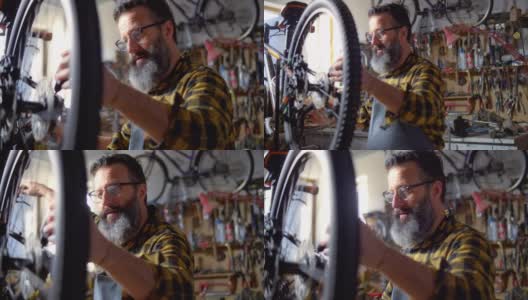 SLO MO Man在车间维修一辆自行车高清在线视频素材下载