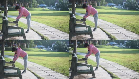 一位亚裔中国老年妇女早上在公园里锻炼，系着她的鞋子高清在线视频素材下载