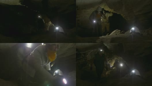 一群年轻的洞穴学家爬上黑暗狭窄的洞穴高清在线视频素材下载