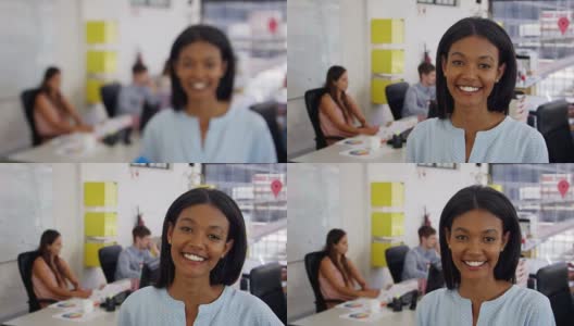 办公室里的一名年轻黑人女性走进焦点，面带微笑高清在线视频素材下载