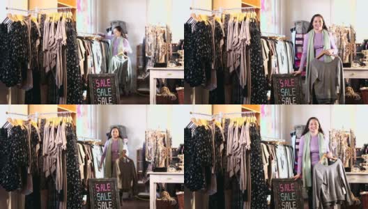 西班牙裔女售货员在服装店的销售标志高清在线视频素材下载