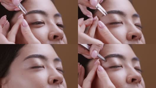 美容师在化妆前拔除年轻的亚洲女人的眉毛高清在线视频素材下载